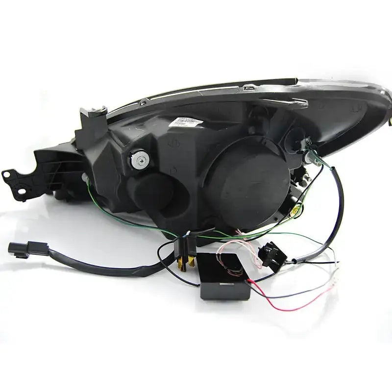 Hovedlys Mitsubishi Lancer 7 04-07 Angel Eyes Chrome vist bakfra med ledninger og kontakter på hvit bakgrunn.