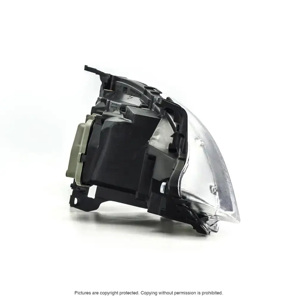 Headlamp Opel Corsa C 03-10 sett fra skrå bakside med svart hus og klar plastdeksel.