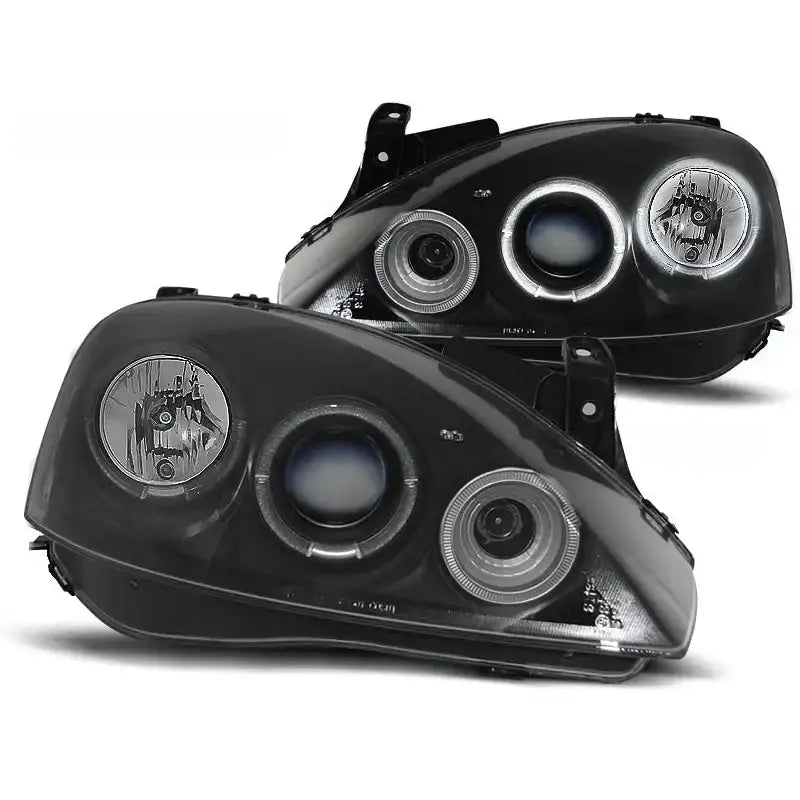 Frontlykter Opel Corsa C Angel Eyes Black med tre runde lyselementer og kromdetaljer, vist fra skrå vinkel.