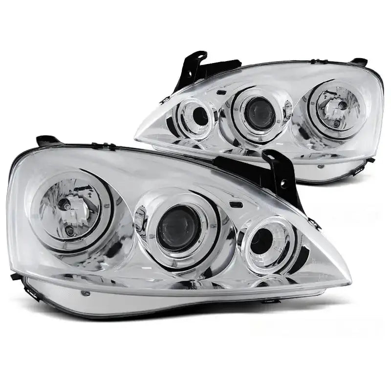 Hovedlykter Opel Corsa C Angel Eyes Chrome med klart glass og krominnfatning, sett fra skrå vinkel.