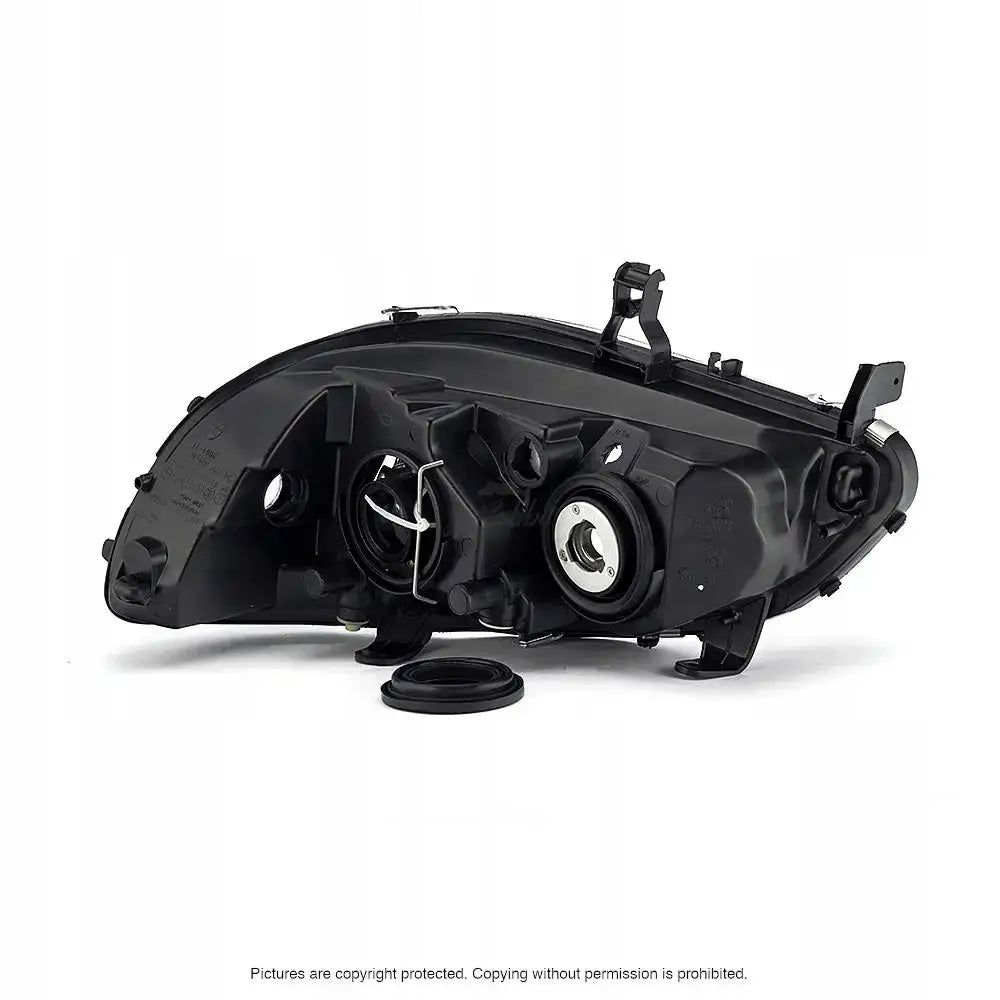 Headlamp Opel Zafira 99-05 sett bakfra med åpninger for lyspærer og løs gummipakning foran.