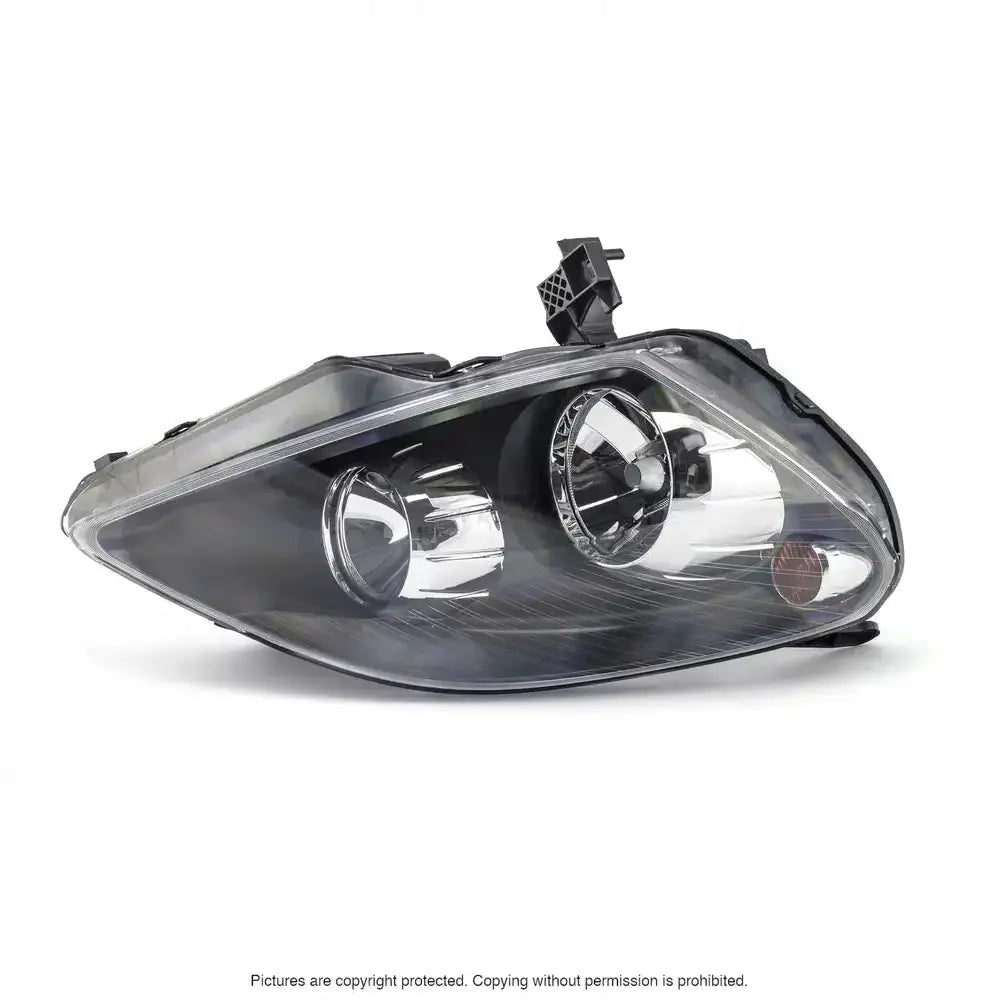 Headlights Opel Zafira B 05-08 i klart glass og sort plast, vist fra skrå vinkel med to reflektorer.