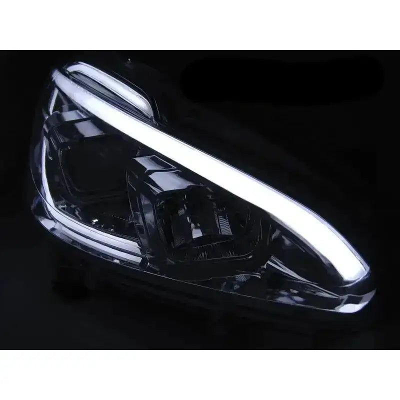 Headlamp Peugeot 208 Tube Light Chrome med hvit LED-lyslist, sett skrått forfra.