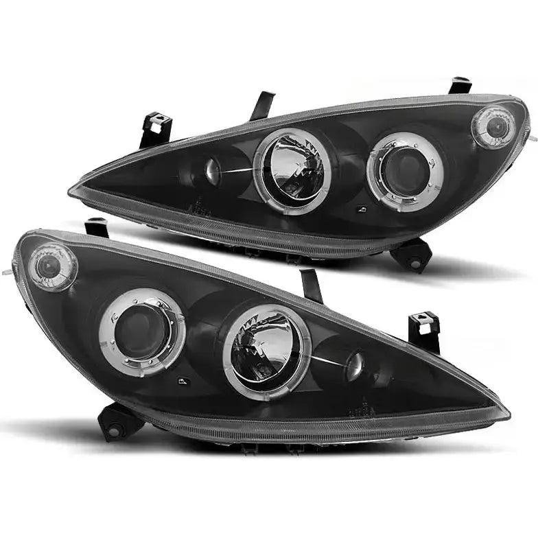 Hovedlykter Peugeot 307 Angel Eyes med sort innside, klare glass og doble runde lys, sett fra skrå vinkel.