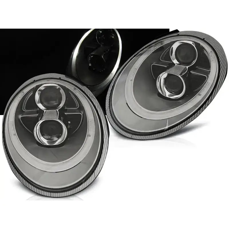 Frontlykter Porsche 911 997 sølv xenon, to ovale lykter med reflektorringer sett fra skrå vinkel.