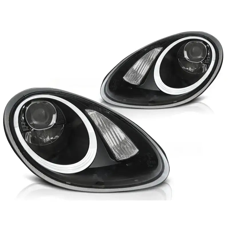 Hovedlykter Porsche Boxster 987 sorte HID med hvit LED-ring og integrert blinklys, sett skrått forfra.