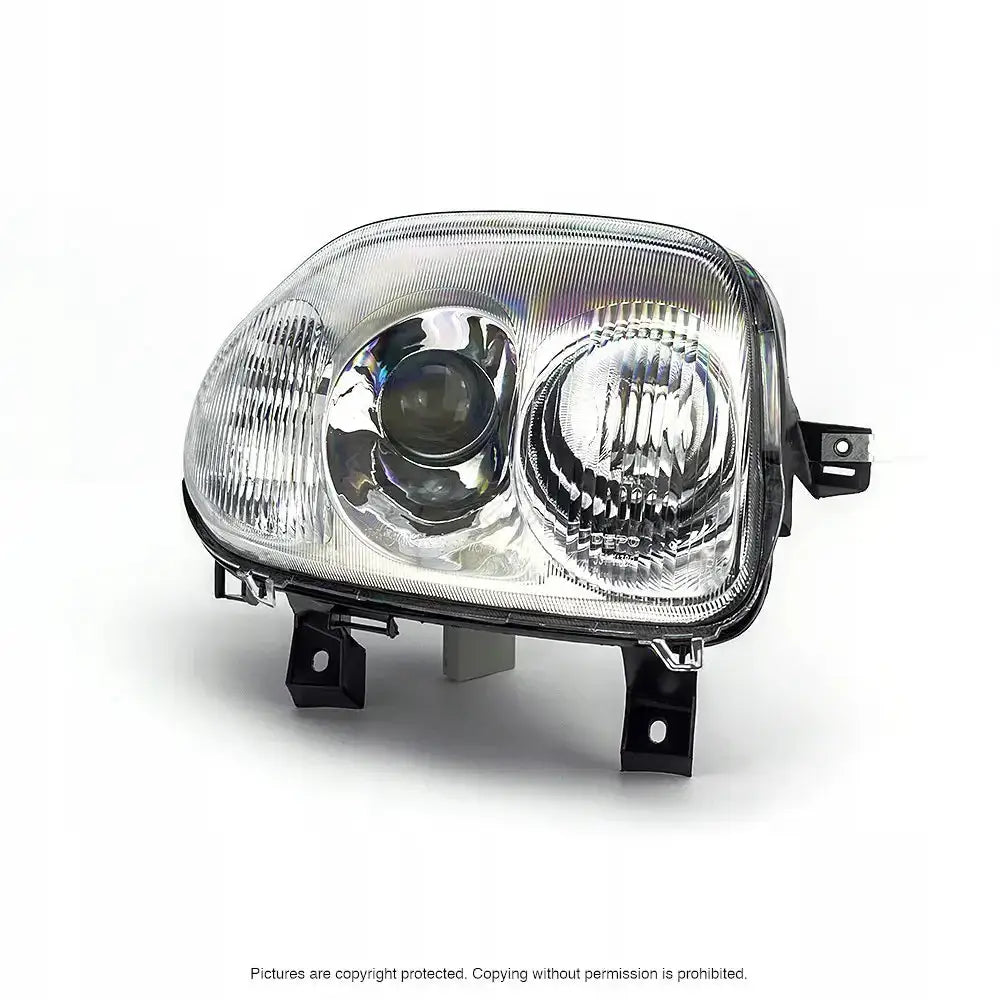 Hovedlykter Renault Clio II 98-01 med klare glass, to reflektorer og sorte festebraketter synlig.