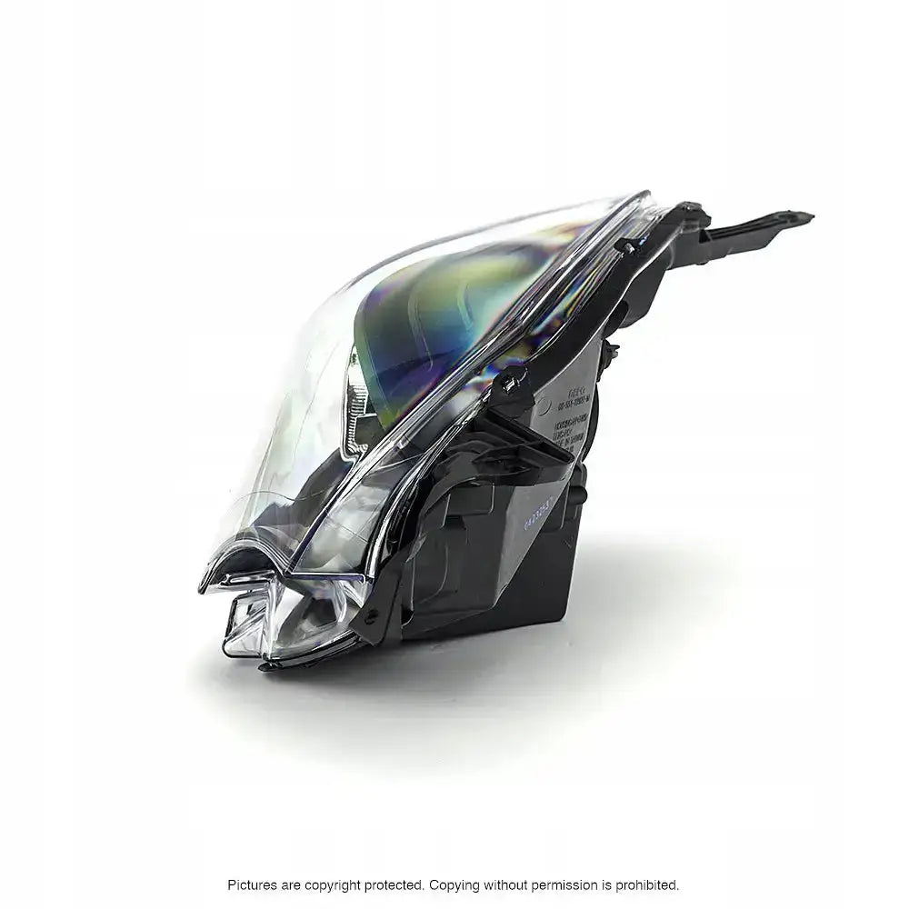 Hovedlys Renault Twingo 11-14 H4 med klar plastlinse og sorte detaljer, vist fra skrå vinkel.