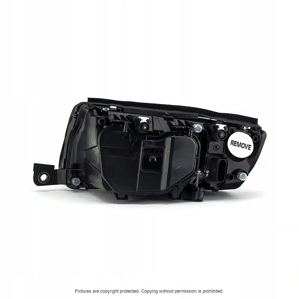 Headlamp Skoda Fabia 99-08 sett bakfra med monteringspunkter og hvit "REMOVE"-etikett til høyre.