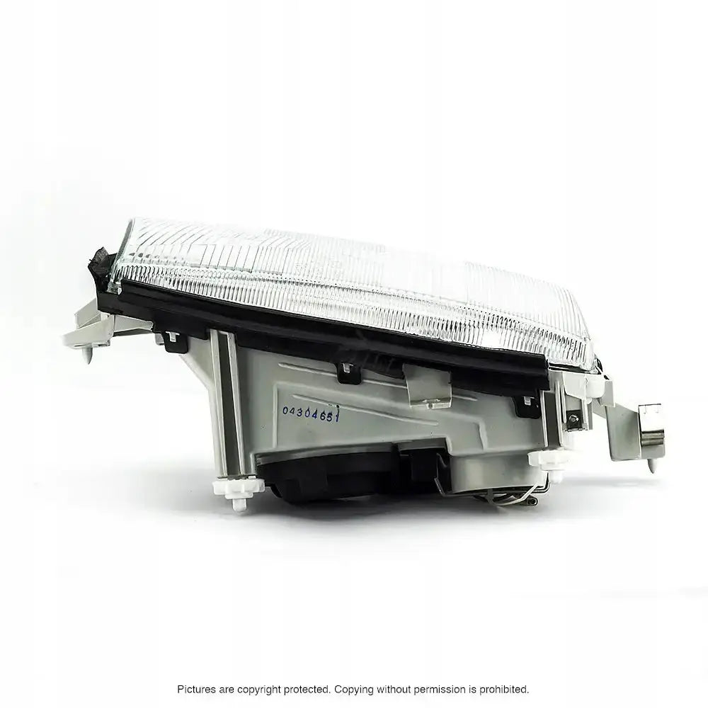 Frontlykter Skoda Octavia 1 96-00 vist fra siden med klar plastlinse og sølv bakside på hvit bakgrunn.