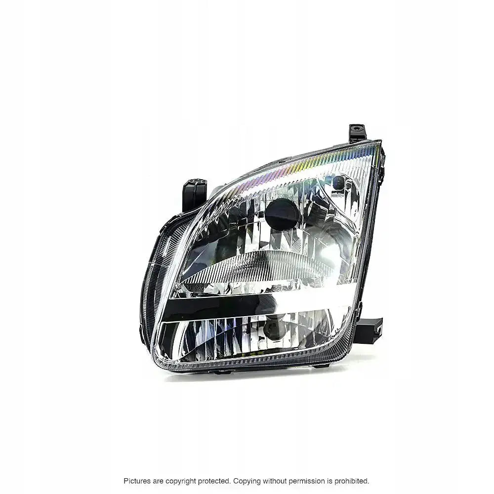 Hovedlykter Suzuki Ignis II 03-07 H4 i klart glass og svart plast sett fra skrå vinkel mot venstre.