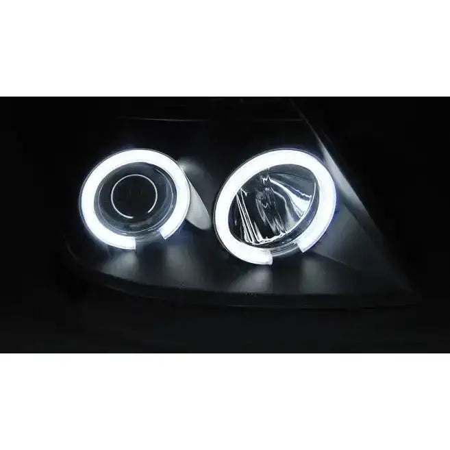 Hovedlys Suzuki Swift CCFL Angel Eyes Black med hvite LED-lyssirkler sett forfra i mørket.