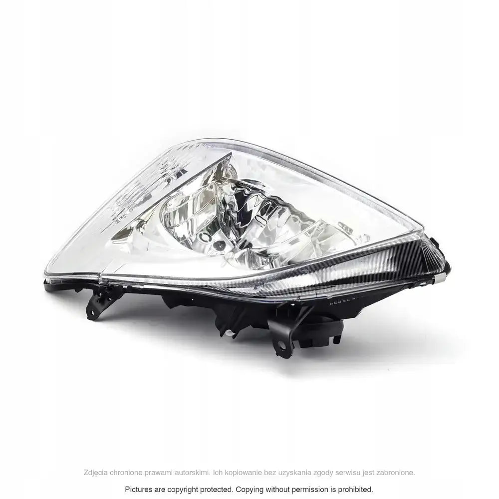 Headlamp Toyota Corolla E12 02-04 med klart glass og svart ramme, sett skrått forfra.