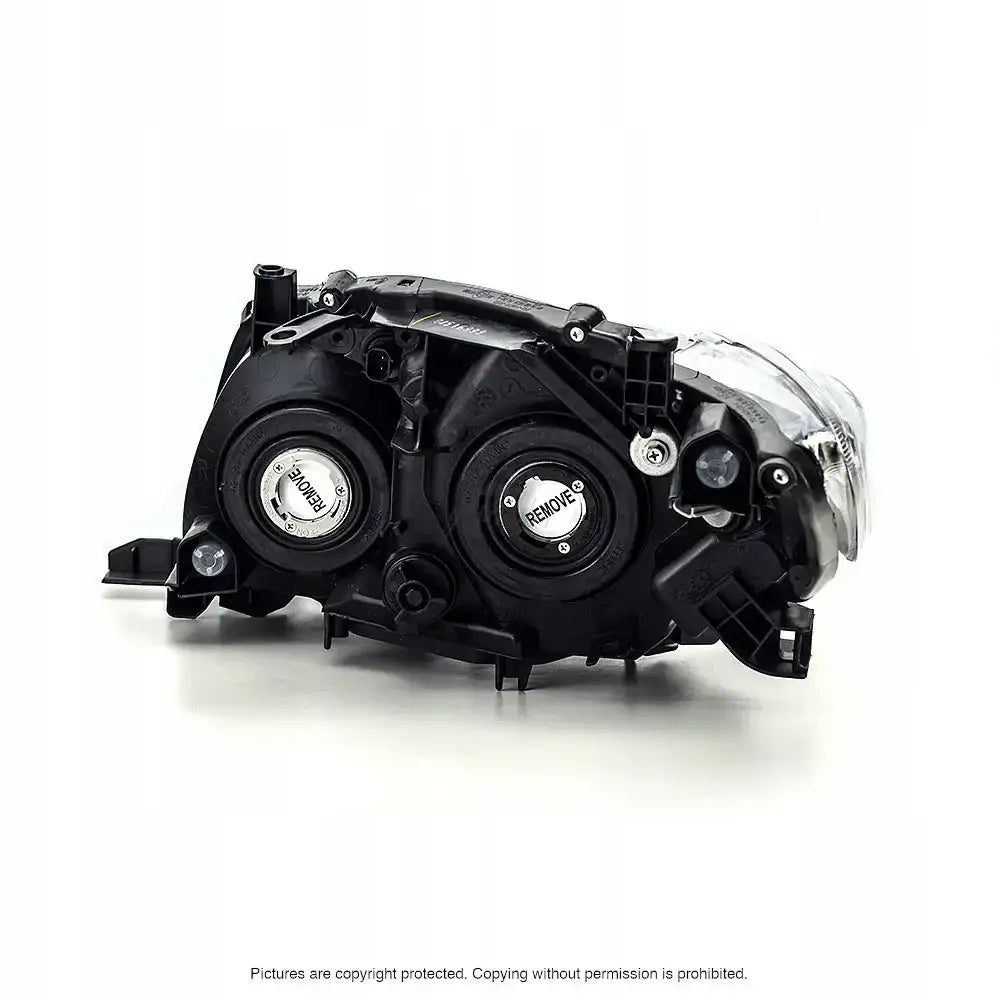 Headlights Toyota Corolla E15 sett bakfra med svarte plastdeksler, metallfester og klart glass.