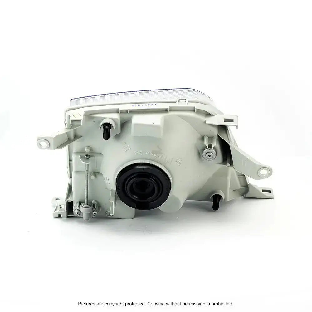 Headlamp bakside av Toyota Land Cruiser J90 frontlykt med svart tetning og festepunkter.