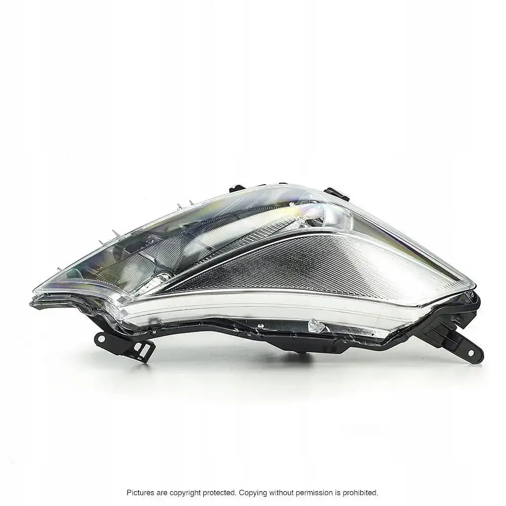 Frontlykter Toyota Yaris 10-14 med sorte detaljer, sett fra siden mot hvit bakgrunn.