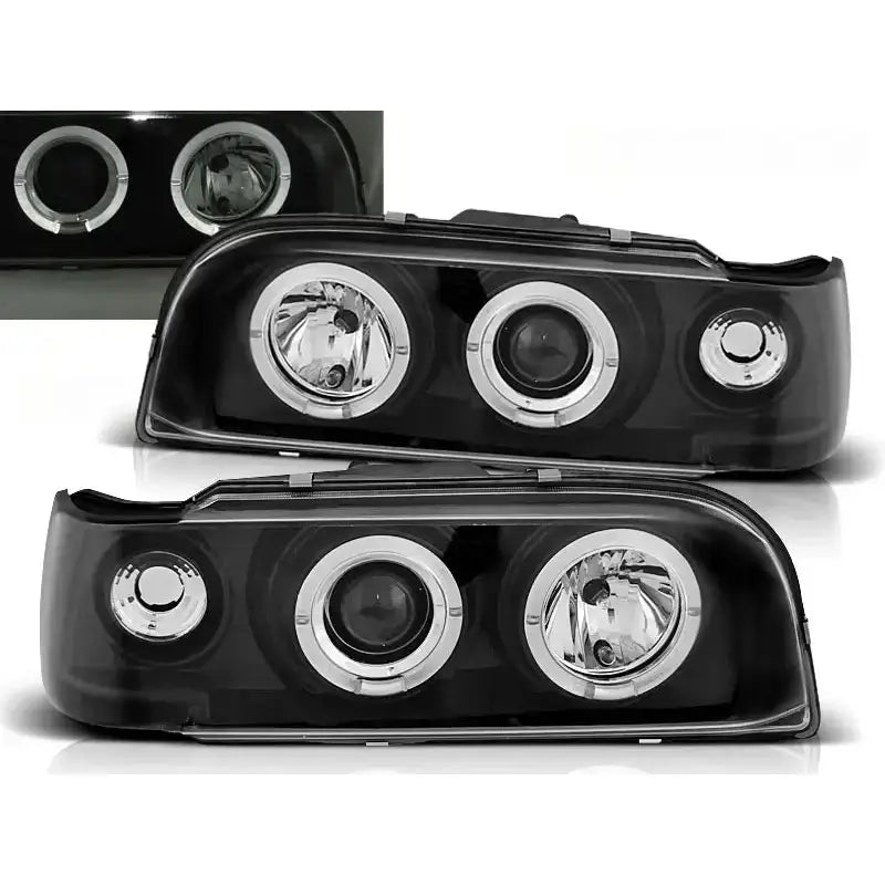 Frontlykter Volvo 850 Angel Eyes Black med svart hus og kromringer, skrå vinkel mot hvit bakgrunn.