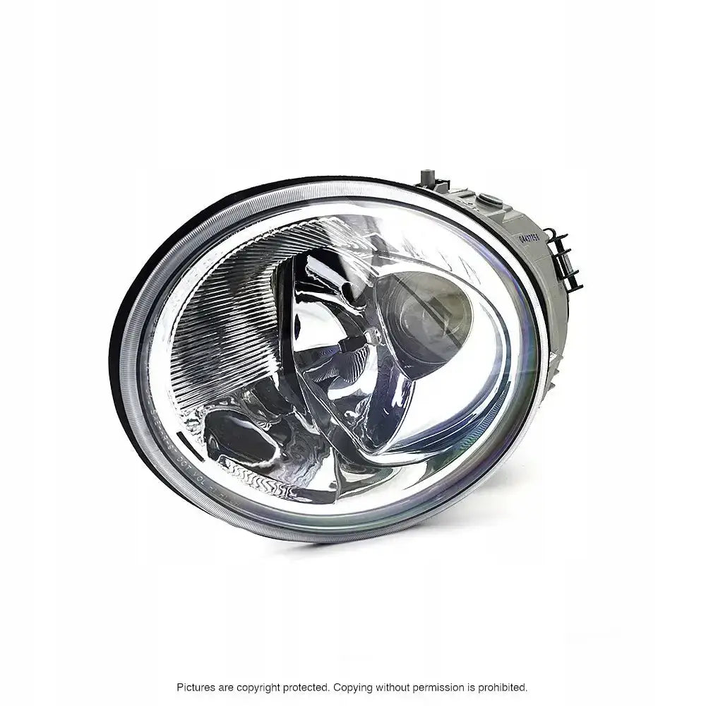 Hovedlykter Vw Beetle 98-05 H1 i oval form, sett fra skrå vinkel med synlige tekniske detaljer.