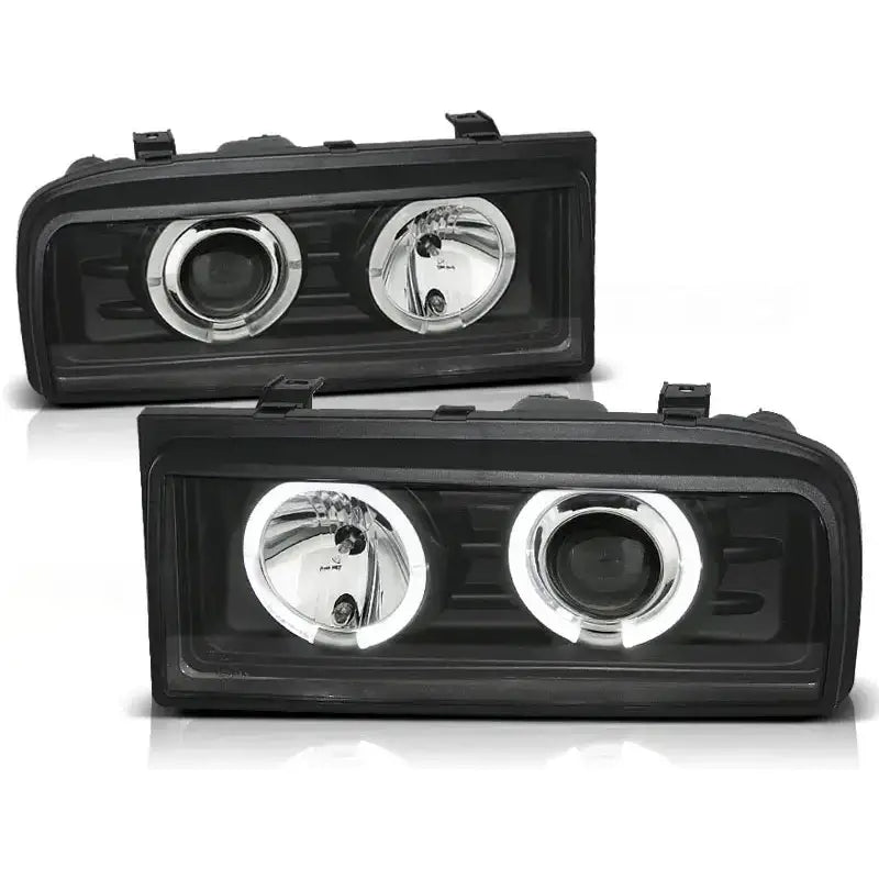 Frontlykter Vw Corrado 88-95 Angel Eyes Black med svart ramme og to runde reflektorer, sett forfra.
