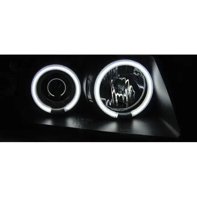 Hovedlys Vw Passat B5 Angel Eyes CCFL Black med to runde lykter og hvite LED-ringer, sett forfra.