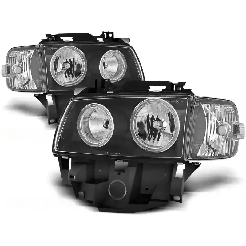 Hovedlykter Vw T4 Angel Eyes Black med to runde reflektorer og rektangulære blinklys, sett skrått forfra.