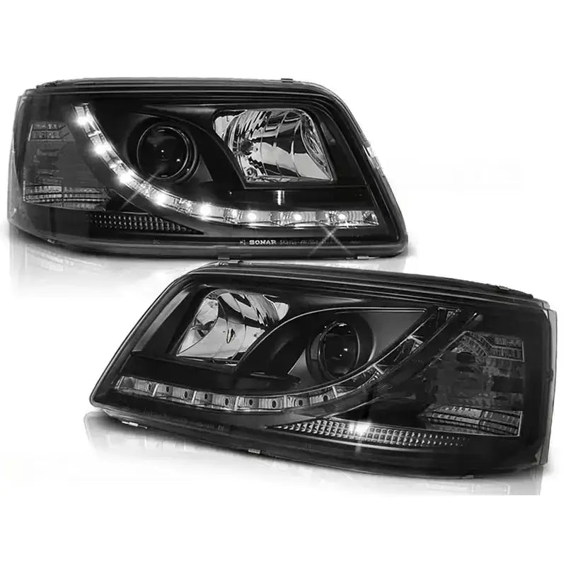 Frontlykter Vw T5 04.03-08.09 Tru DRL Black med klare linser og LED-lys, vist fra skrå vinkel.