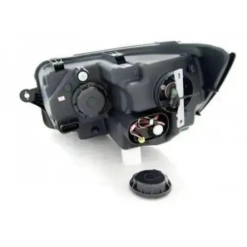 Headlamp bakside av Vw T6 15- Black-Chrome Tube Light LED med løs rund deksel på hvit bakgrunn.