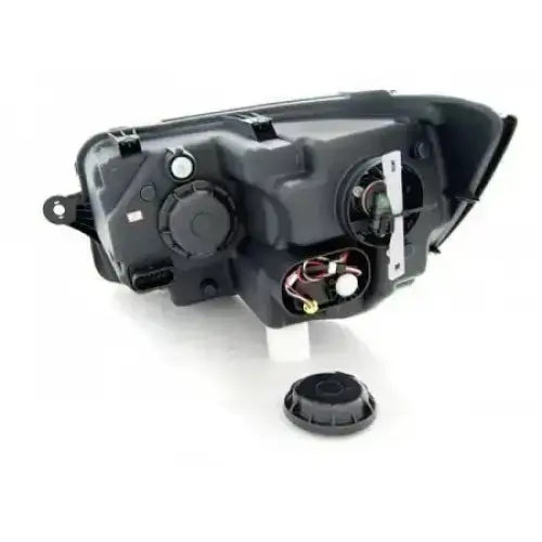 Hovedlykter Vw T6 15- bakside med åpne lokk og synlige elektriske kontakter.