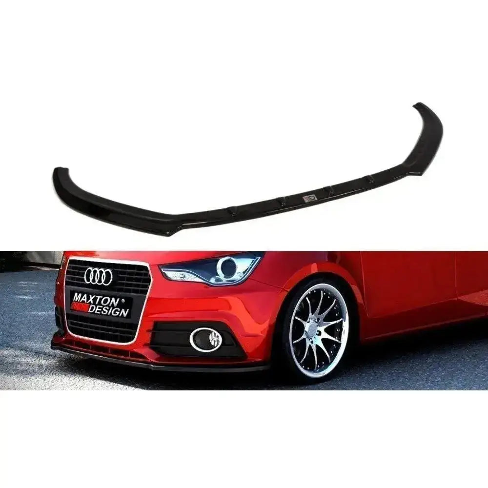 Frontspoiler til Audi A1 Preface Model, sort plast, montert på rød bil sett forfra fra lav vinkel.