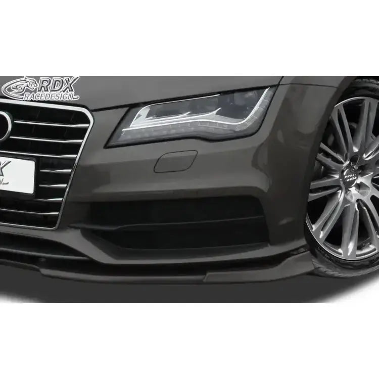Frontleppe Audi A7 S-Line detaljbilde med fokus på sort spoiler, grill, hovedlykt og aluminiumsfelg.
