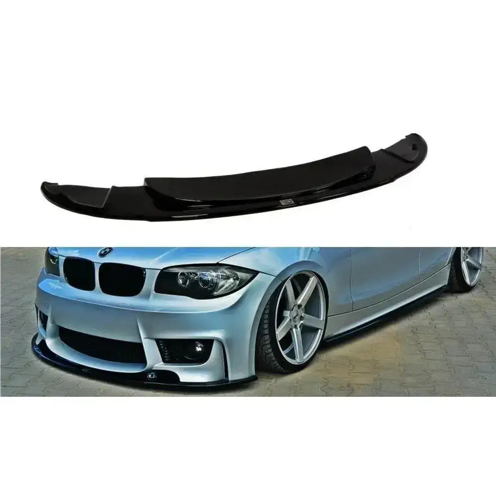 Frontspoiler til BMW 1 E87 M-Design i blank svart plast, montert på sølvfarget bil med senket understell.