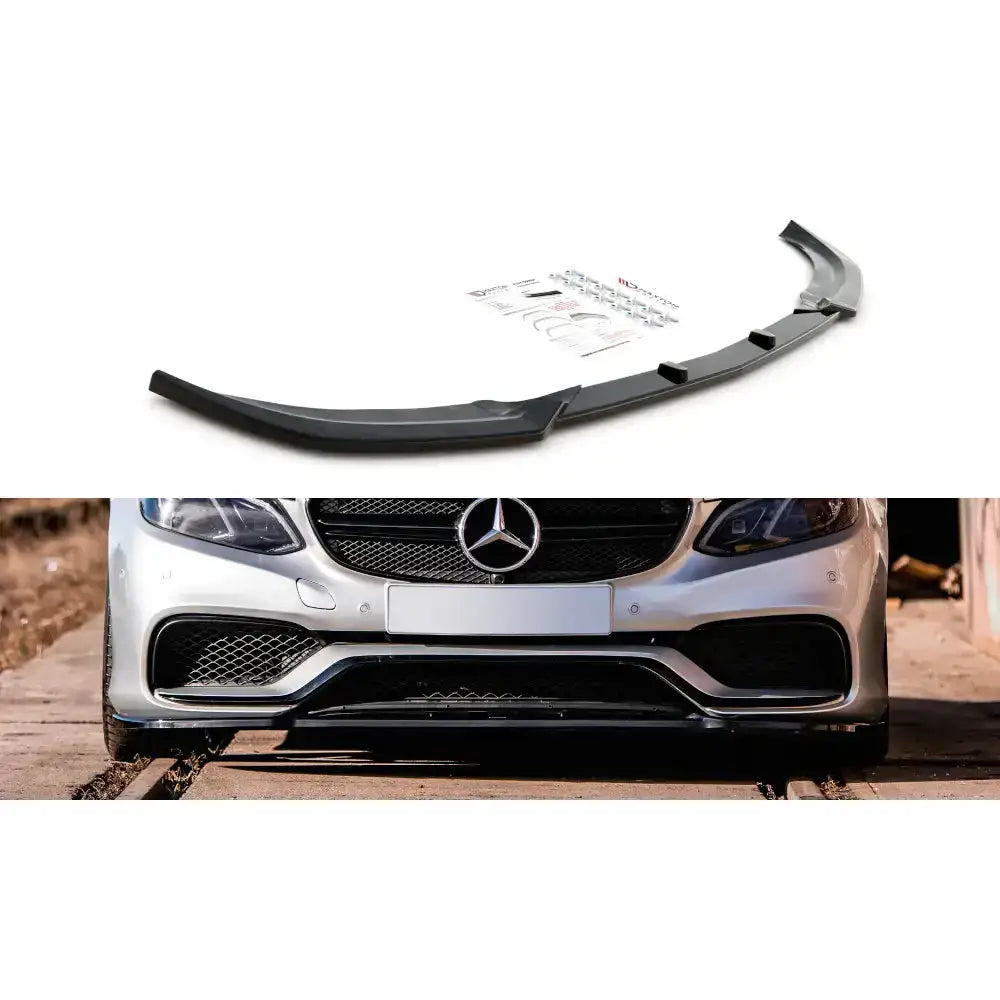 Frontspoiler til Mercedes E63 AMG W212 Facelift, sort plast med monteringsutstyr, vist på sølvfarget bil.