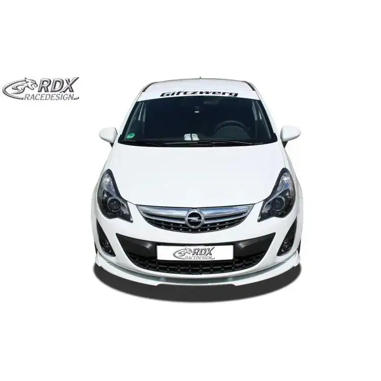 Front splitter på hvit Opel Corsa D Facelift med sort grill, svarte lykter og RDX-logo på skiltholderen.