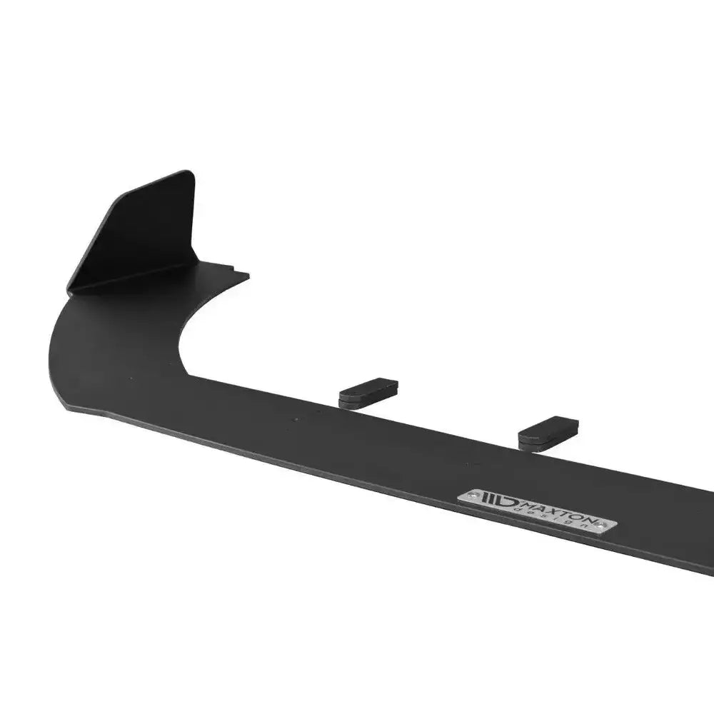 Frontspoiler til Ford Fiesta Mk8 ST, sort plast med kantvinge og metallmerke, sett fra siden.