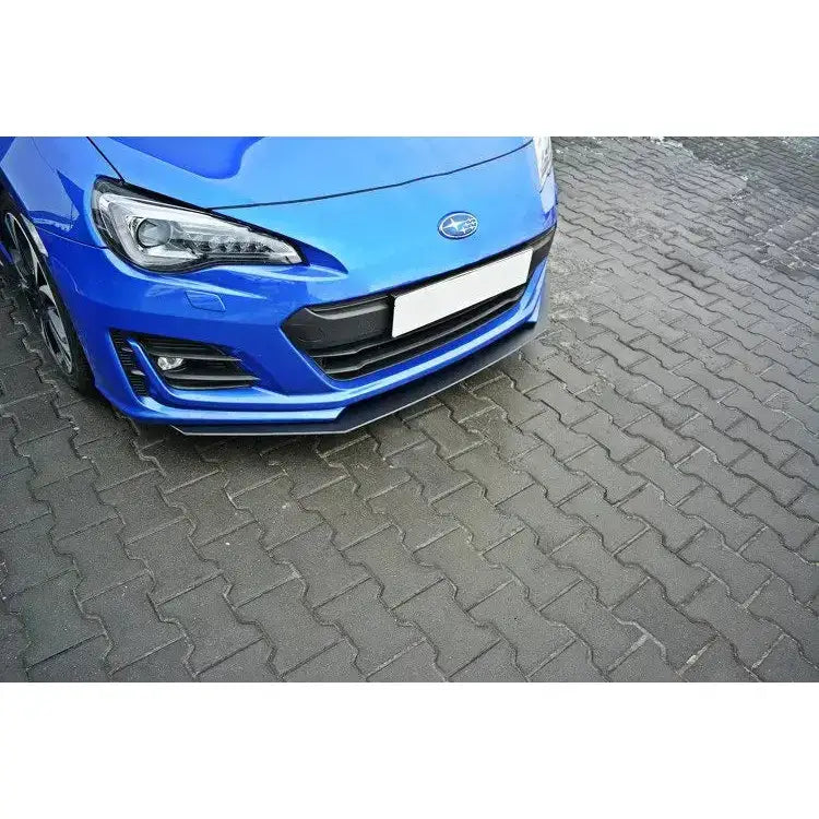 Frontleppe på Subaru Brz Facelift Racing V.3 montert foran på blå bil parkert på grå belegningsstein.