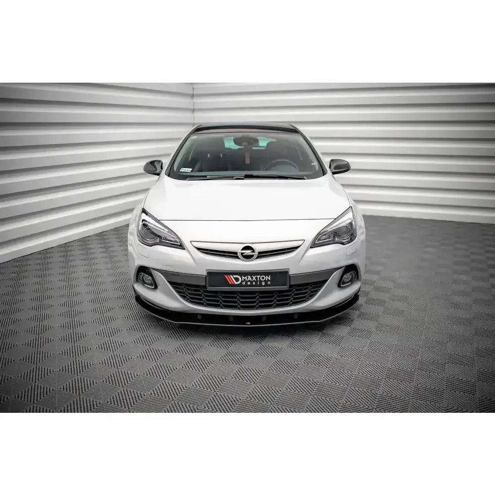 Frontspoiler til Opel Astra GTC OPC-Line J 11-18 montert på hvit bil foran grått, mønstret gulv.