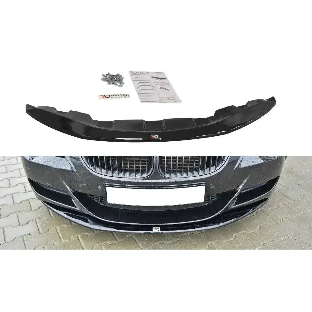 Frontspoiler BMW M6 E63 V.1 i blank svart plast med monteringsskruer og instruksjoner, sett ovenfra.