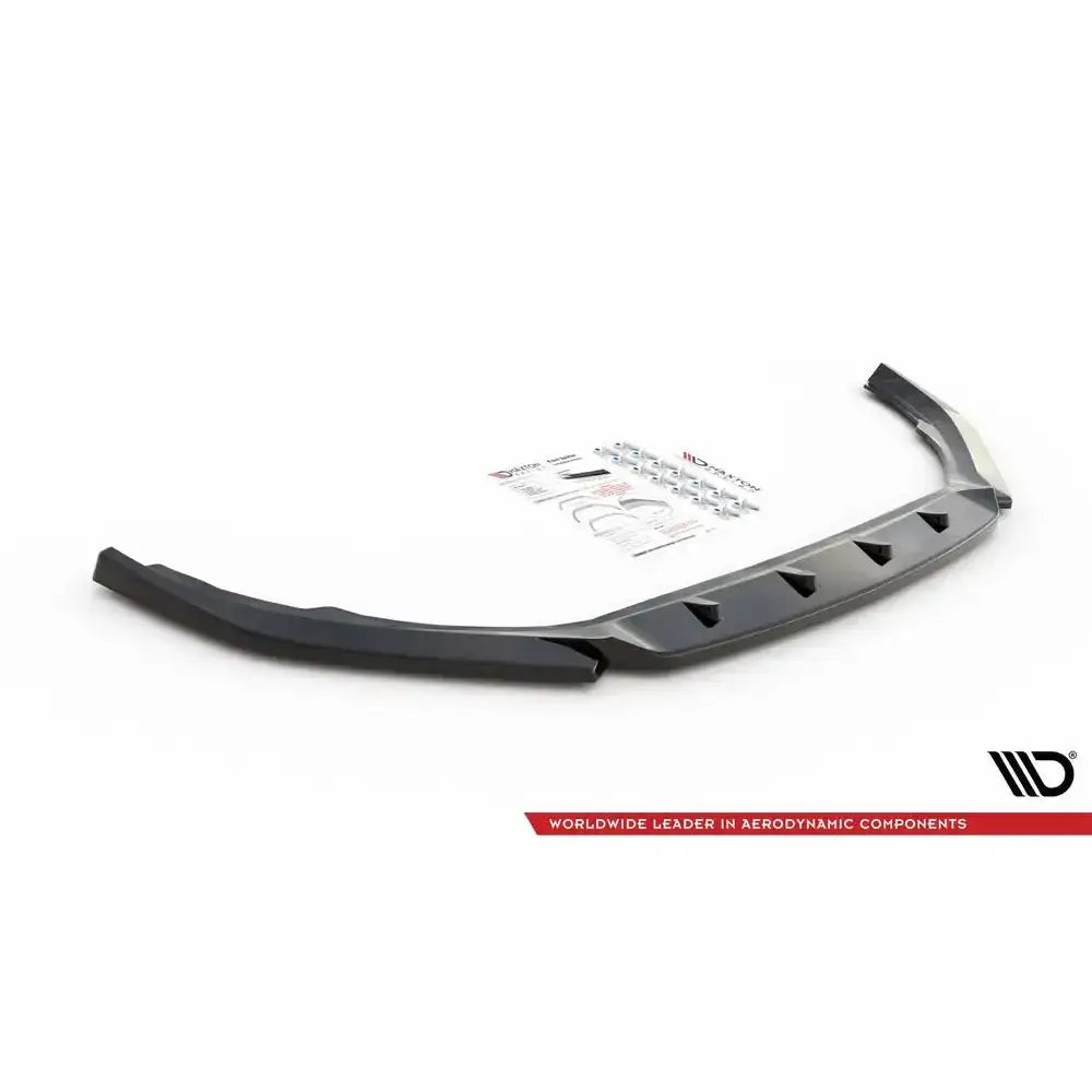 Front splitter av sort frontspoiler Volvo V90 Mk2 med monteringsutstyr og instruksjoner i bakgrunnen.