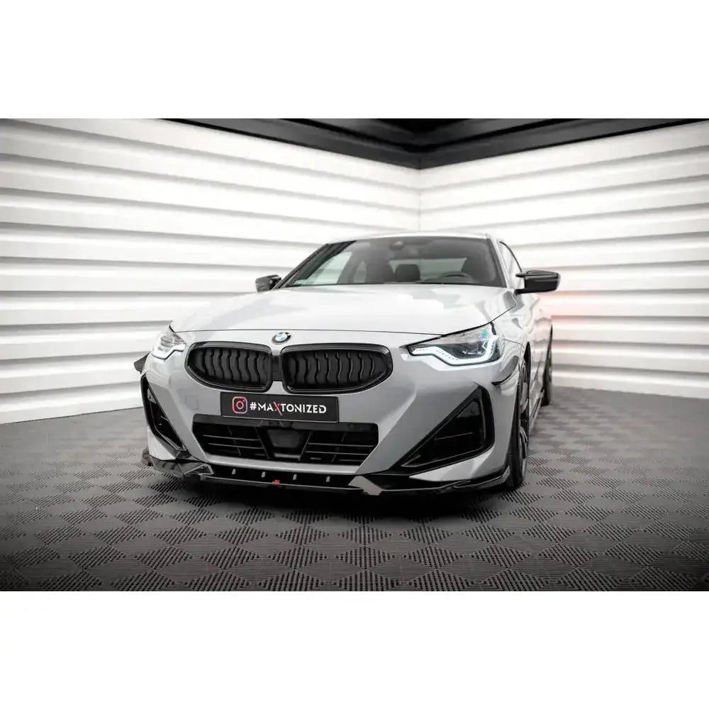Front splitter på BMW 2 Serie Coupe M-Pack G42 med sorte detaljer og sjakkmønstret gulv.