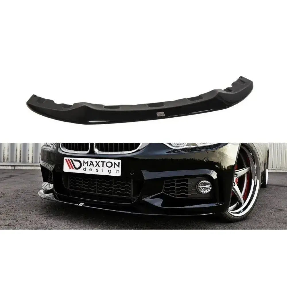 Frontspoiler BMW 4 F32 M-Pack V.2 i sort plast, sett ovenfra og montert på svart bil med sporty detaljer.