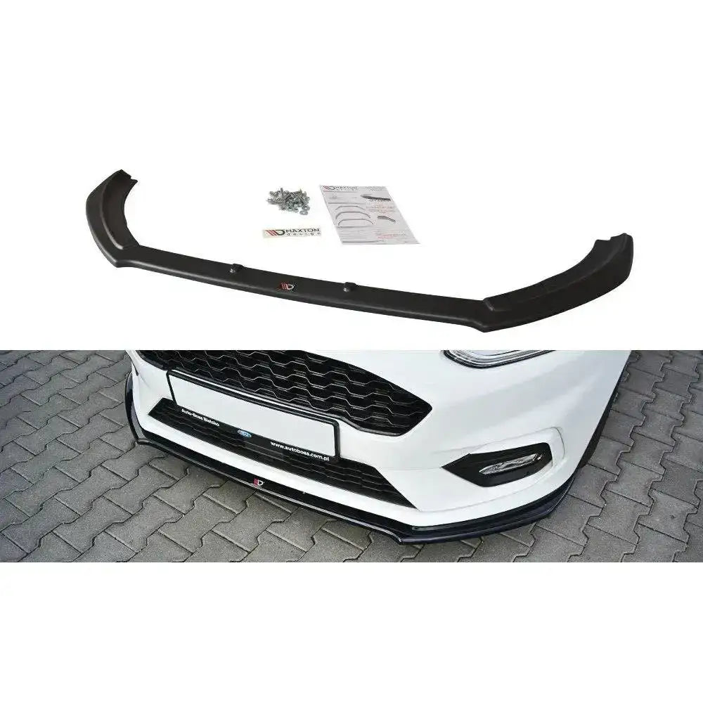 Frontspoiler Ford Fiesta Mk8 St st-Line V.2 sort plast med monteringsutstyr, vises montert på hvit bil.