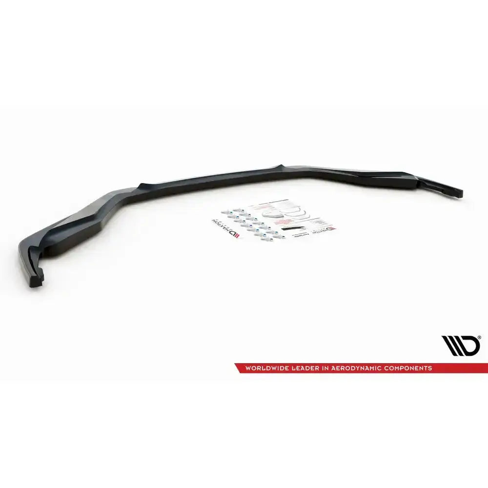 Front lip til Lexus GS F Sport Mk4, sort plast med monteringsutstyr og klistremerker på hvit bakgrunn.