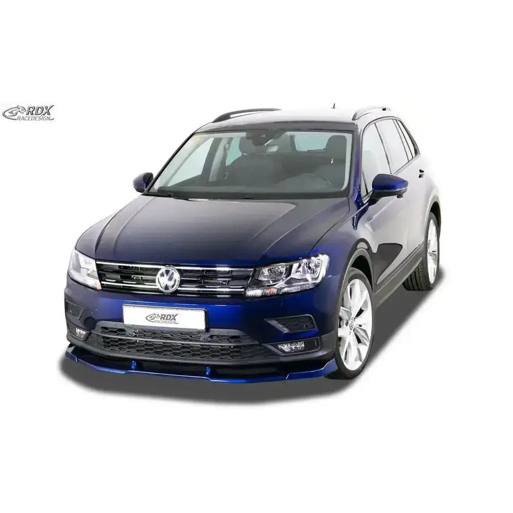 Frontleppe på Volkswagen Tiguan 16- mørkeblå SUV med sølvfelger mot hvit bakgrunn.