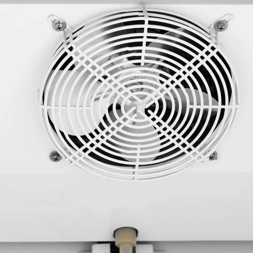 Ventilasjonsvifte til fryseskap, nærbilde av hvitt metallgitter med fire synlige hjørneskruer mot hvit bakgrunn.