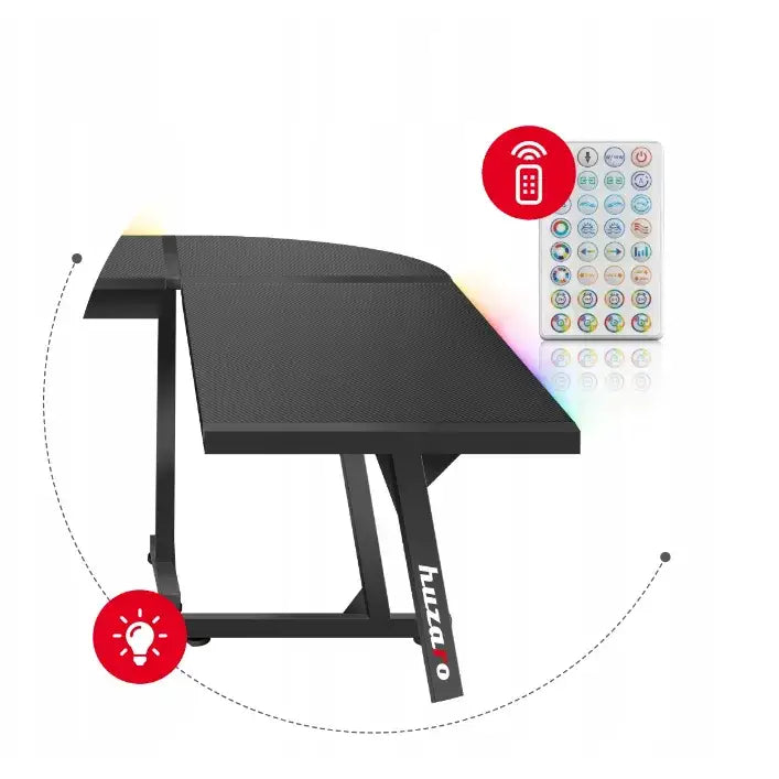 Gaming hjørnebord Huzaro Hero 6.0, skrå forfra med synlig RGB-lys, fjernkontroll og huzaro-logo på benet.