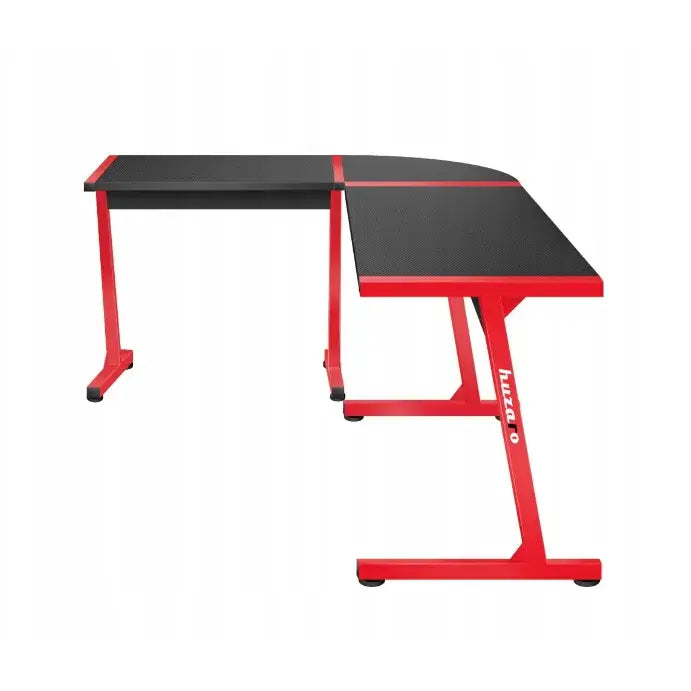 Gaming hjørnebord Huzaro Hero 6.0, L-formet med svarte plater og rødt understell sett fra siden.
