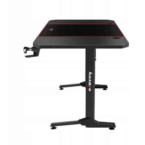 Gamingbord Huzaro Hero 4.7 svart, sidevisning med kopp-holder til venstre og røde detaljer langs bordplaten.