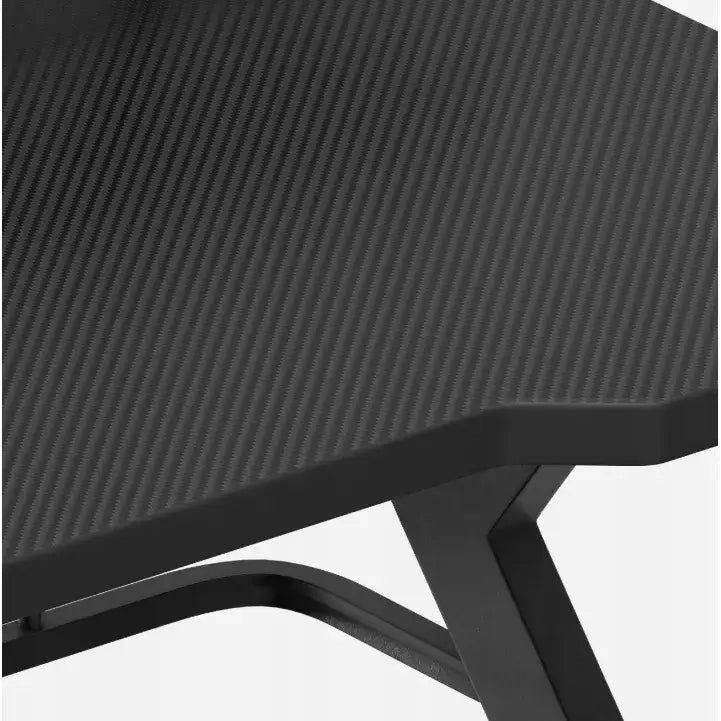 Gamingbord Huzaro Hero 5.0, detaljert nærbilde av svart hjørne med karbonfiberstruktur og robuste metallben.