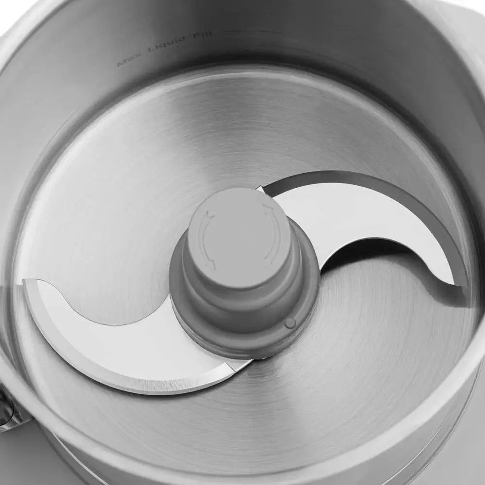 Gastronomisk kuttermaskin, toppvisning av metallbolle med buet dobbeltblad og grått lokk med pilmerker.