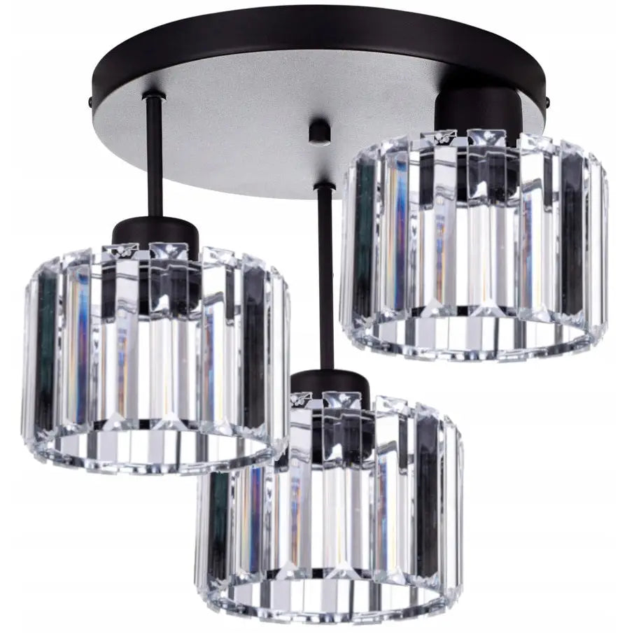 Glass taklampe med tre sylindriske, klare krystallskjermer på sort rund base, sett nedenfra i vinkel.